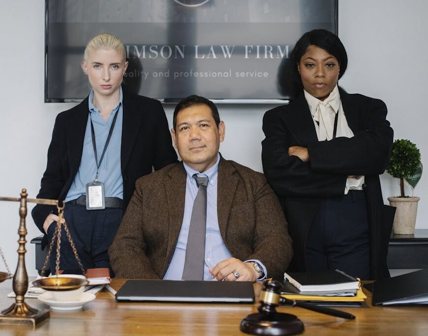 Group of diverse colleagues near table with gavel